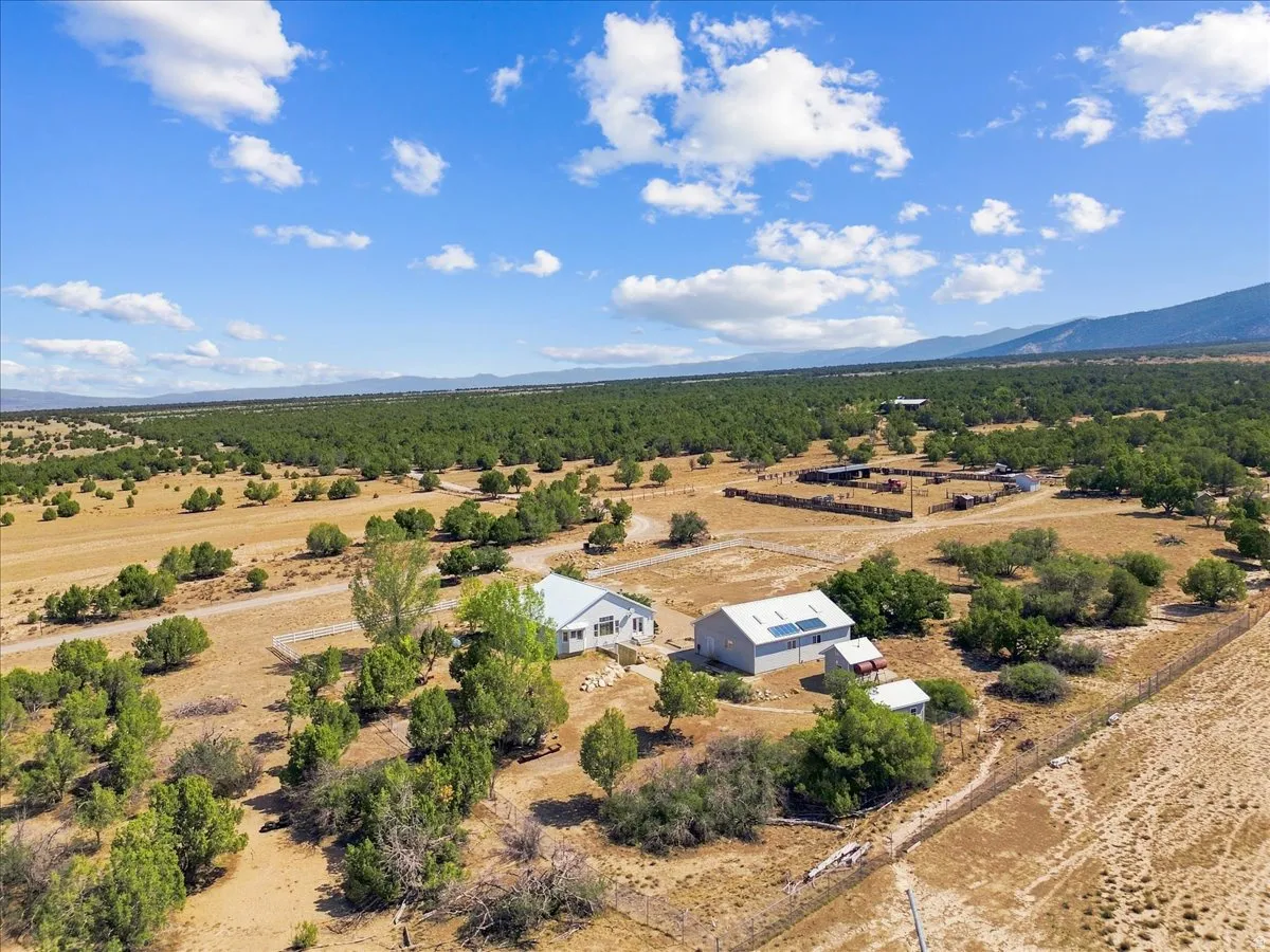 Expansive property featuring a primary residence, an additional dwelling, and multiple outbuildings