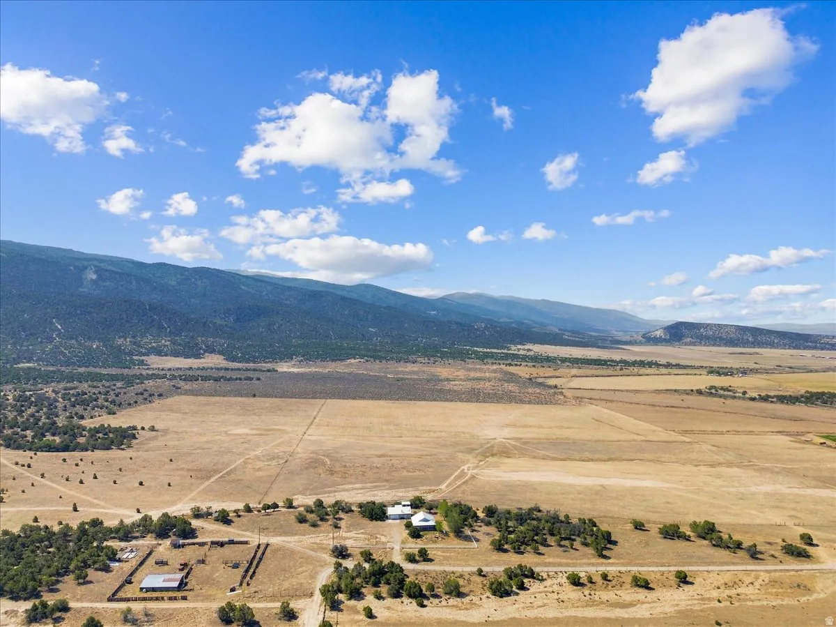 Expansive property featuring mountainous terrain and a clear sky backdrop