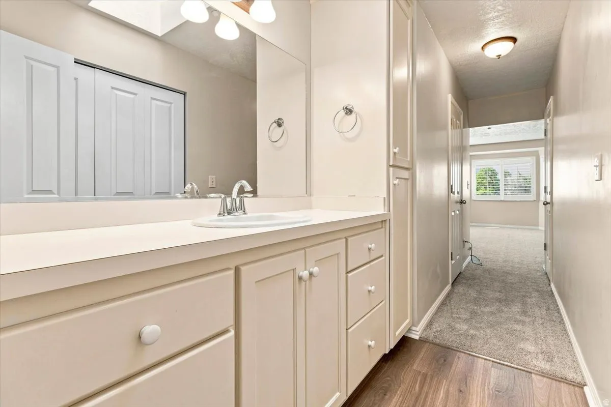 Vanity with an integrated sink and base cabinetry, complemented by a tall built-in storage cabinet