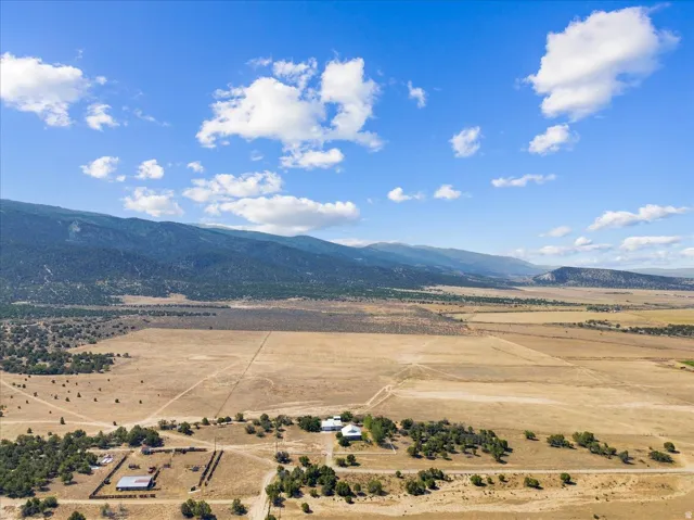 Expansive property featuring mountainous terrain and a clear sky backdrop