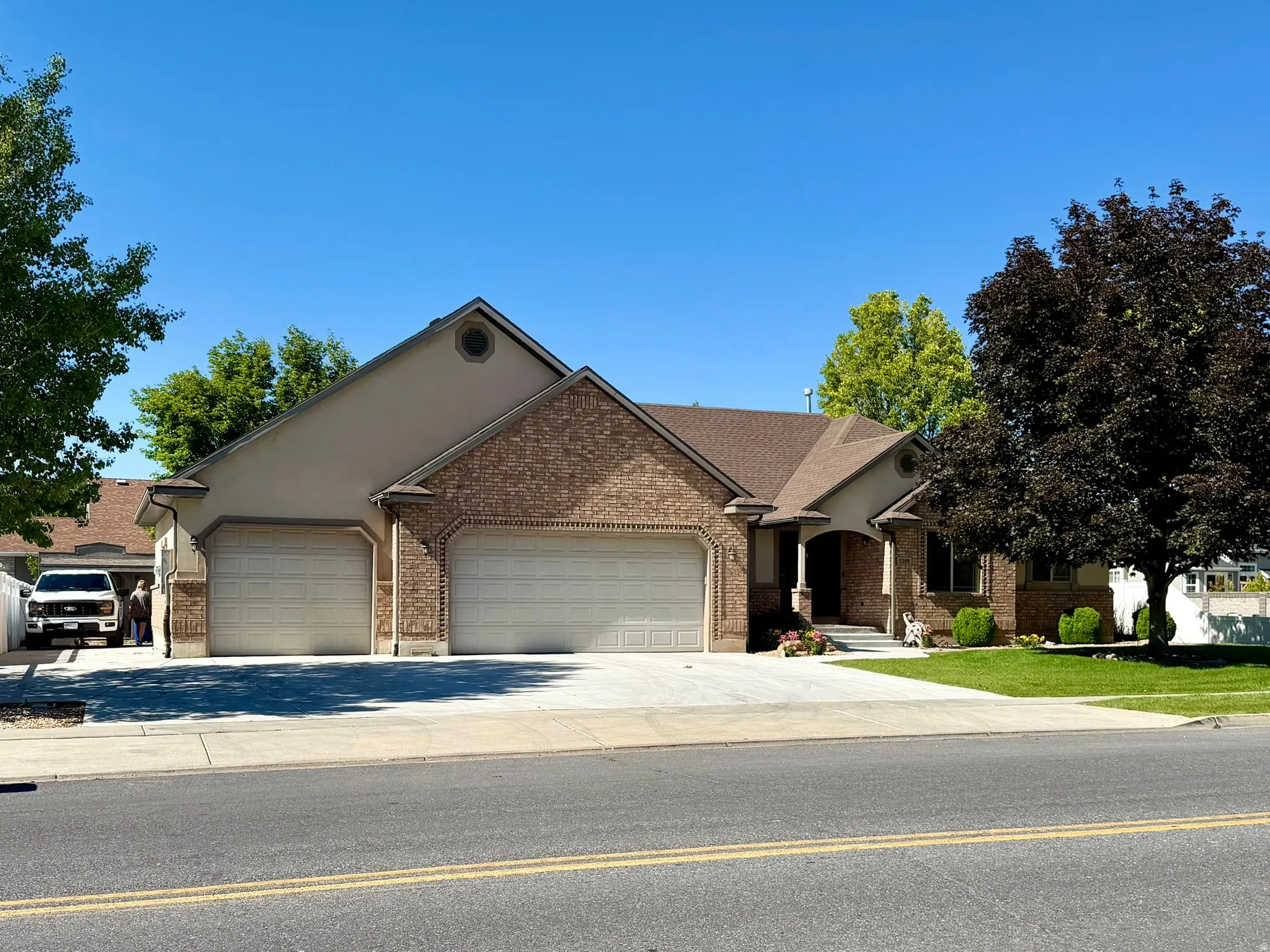 Brick and stucco exterior with an arched entry