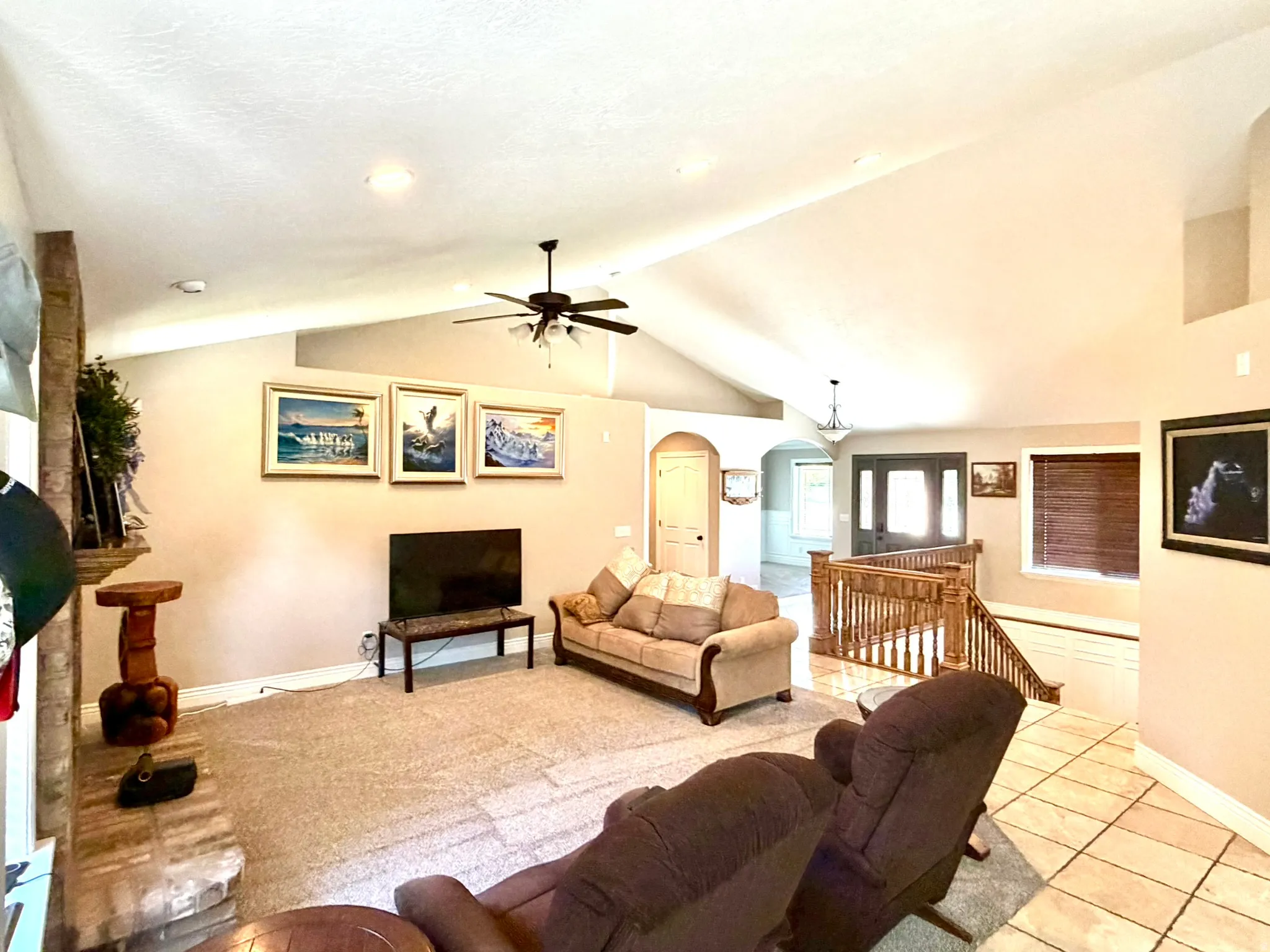 Vaulted ceilings with recessed lighting and a ceiling fan