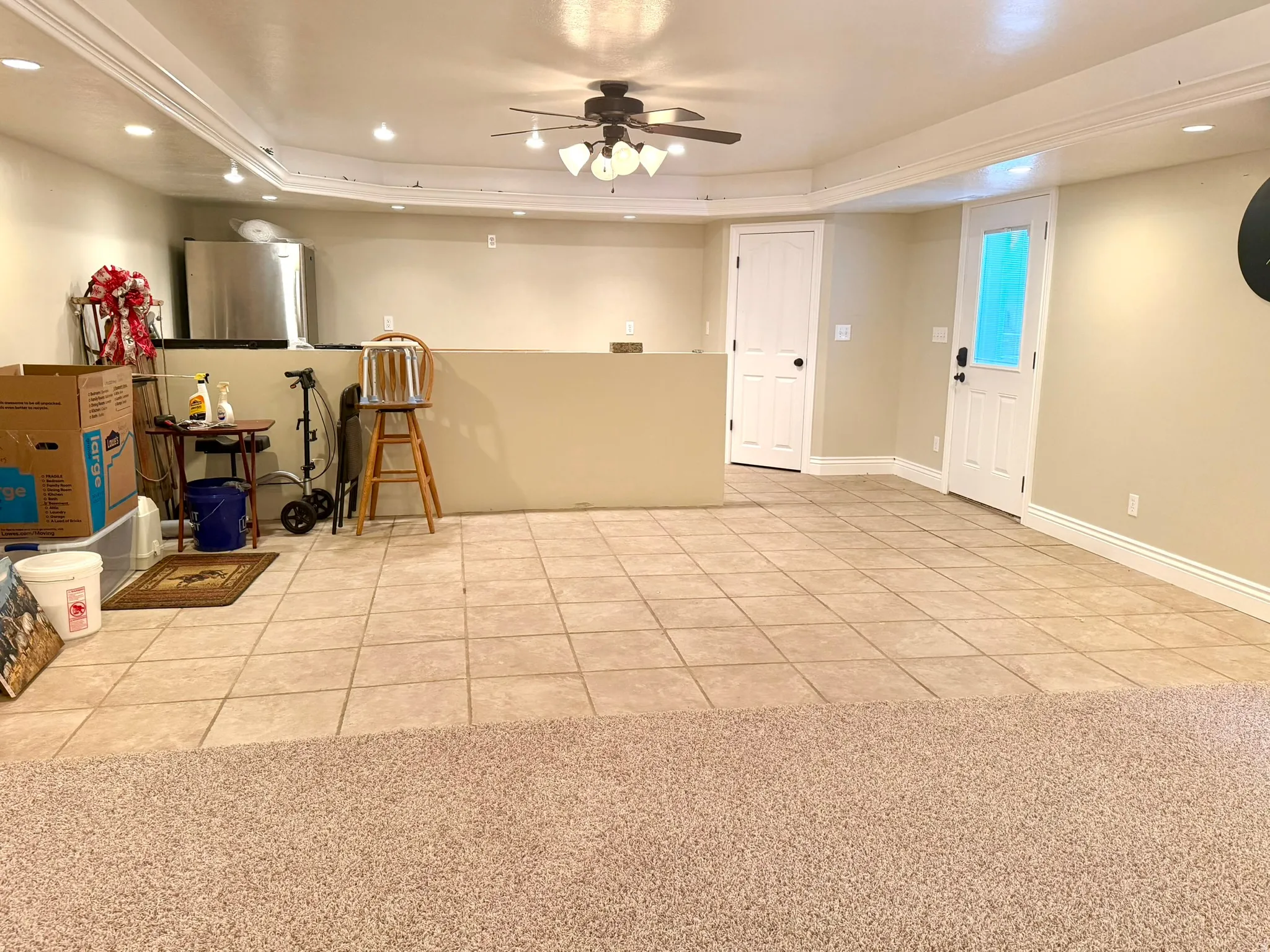 Spacious dining area featuring a mix of tile and carpet flooring, a ceiling fan with integrated lighting, and multiple recessed lights
