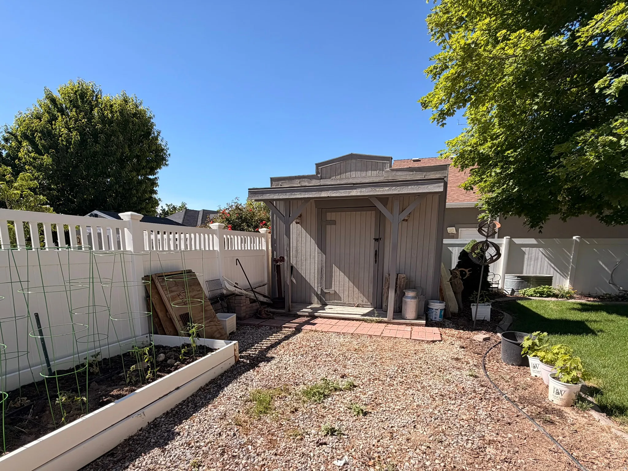 Outdoor storage shed/workshop with power. Board-and-batten siding and a red brick paver entrance
