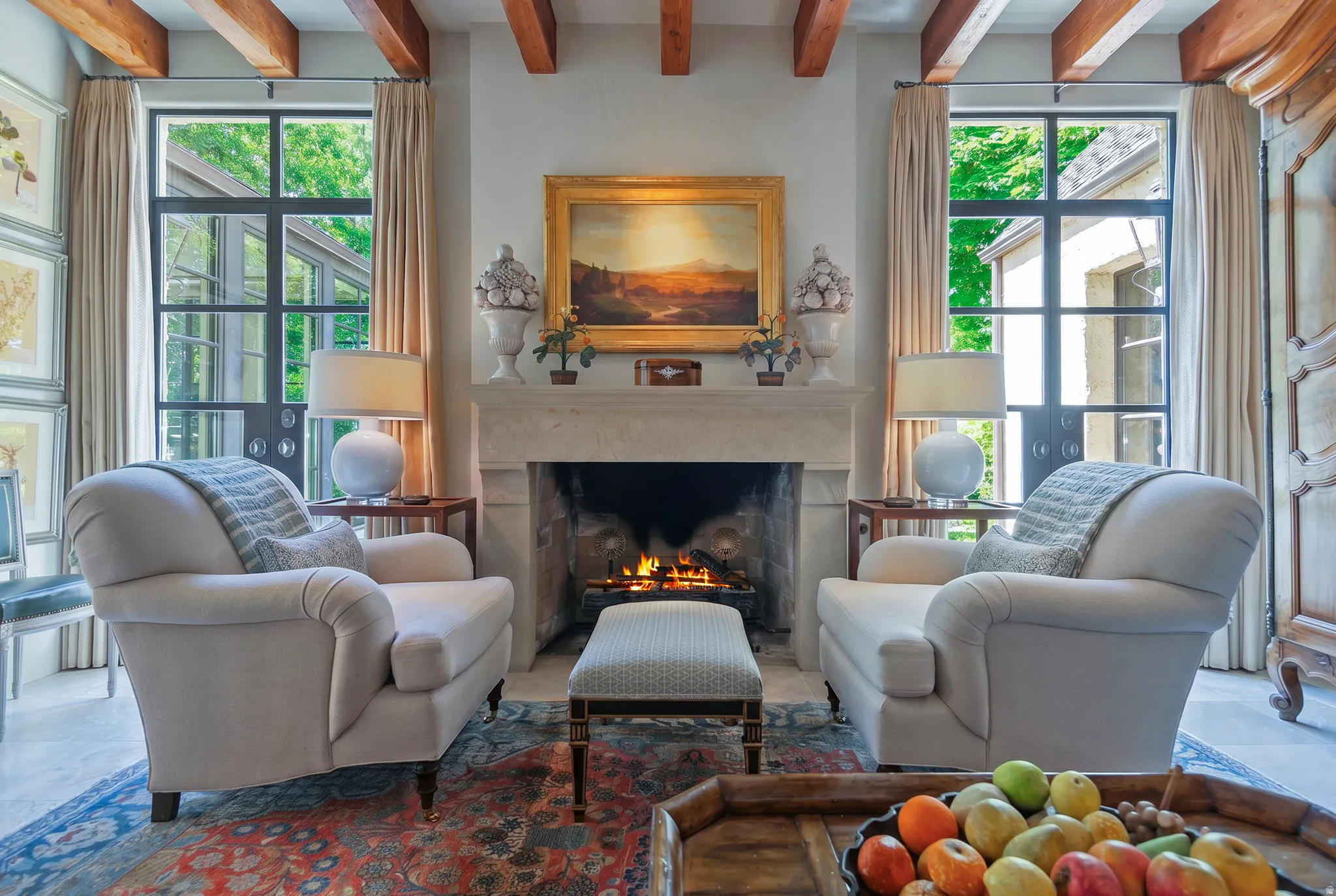 Living area featuring exposed wood ceiling beams and a substantial stone fireplace