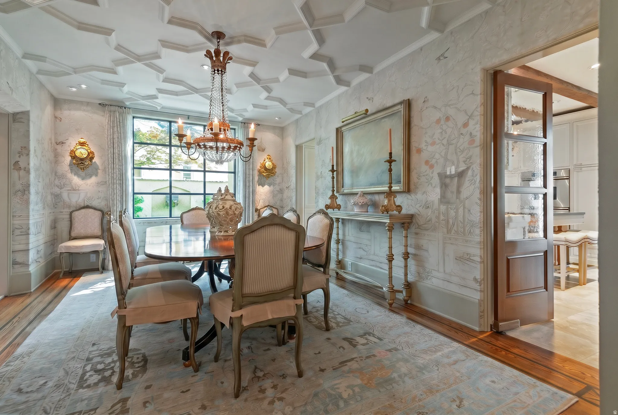 Formal dining area featuring an ornate coffered ceiling and decorative wall treatments