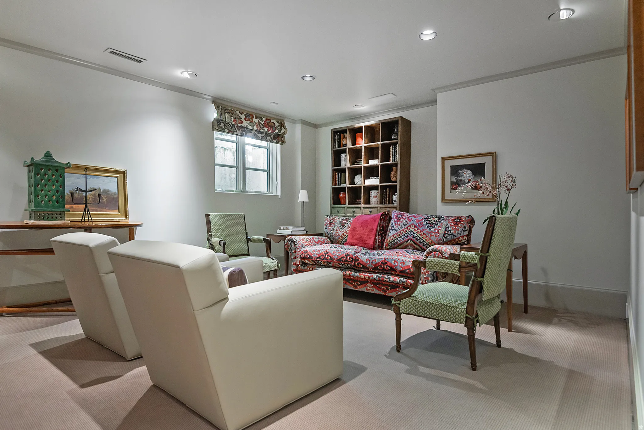 Carpeted room featuring recessed lighting, crown molding, a built-in bookcase, and a window with a fabric valance