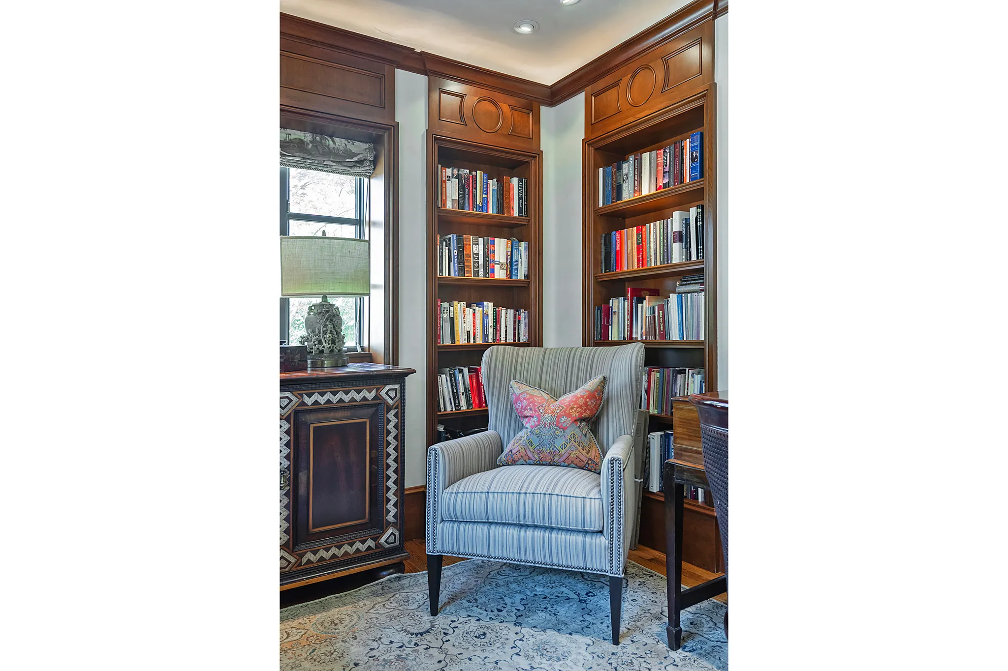 Built-in wood shelving with decorative molding framing a corner