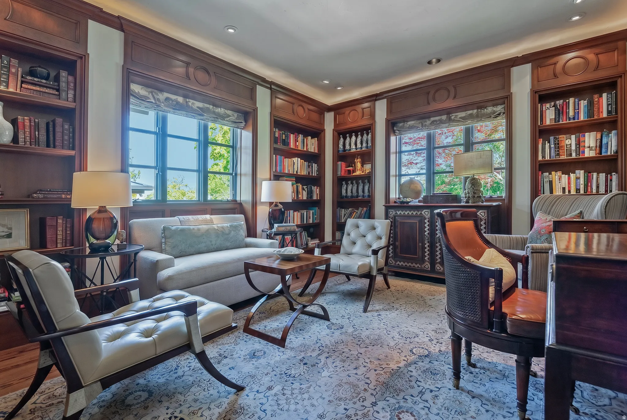 Rich wood-paneled walls with built-in shelving, ornate window trim, and recessed lighting