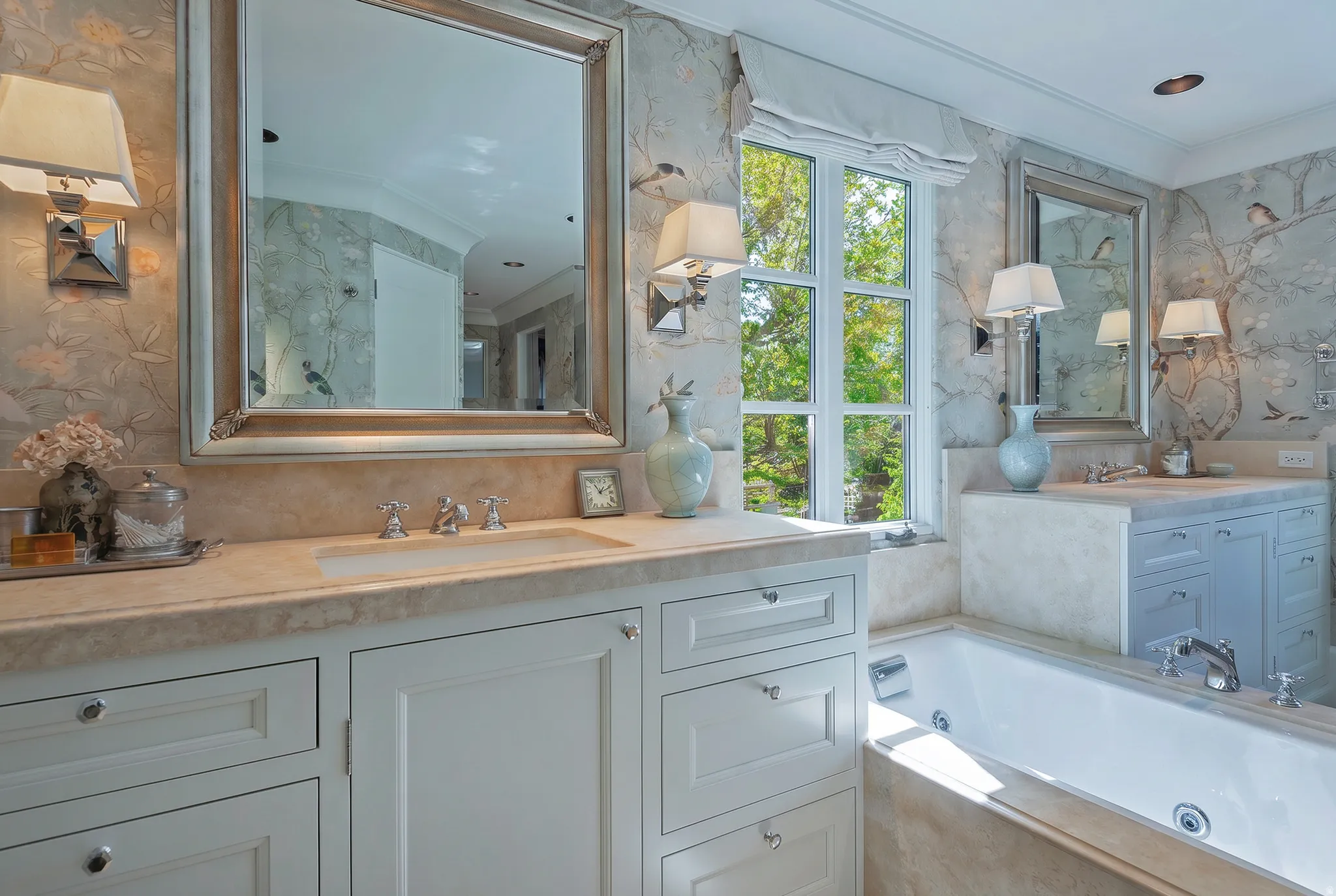 Bathroom featuring dual vanity areas with integral sinks and light-toned countertops