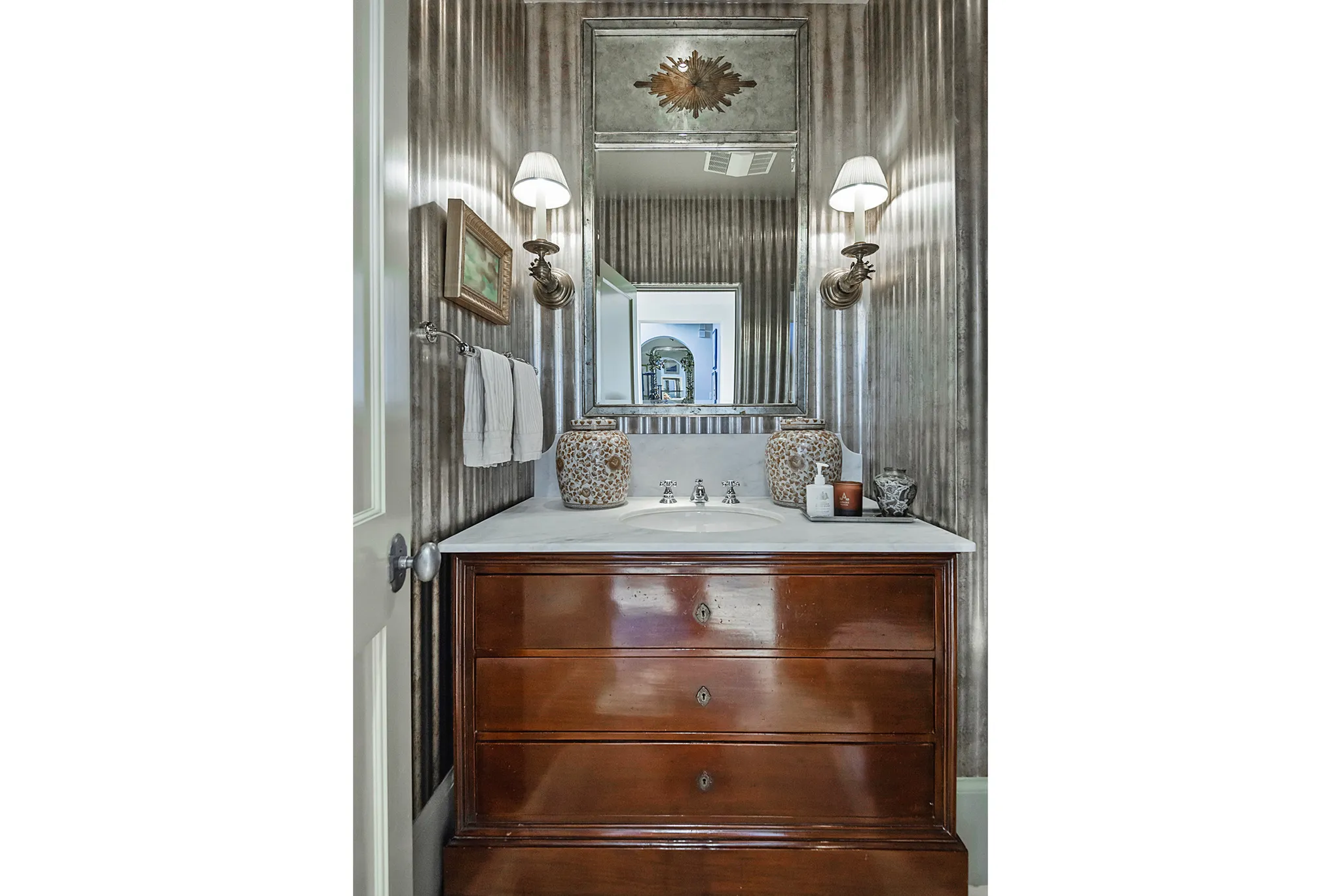 Vanity featuring a dark wood finish with three drawers, white countertop, and integrated sink