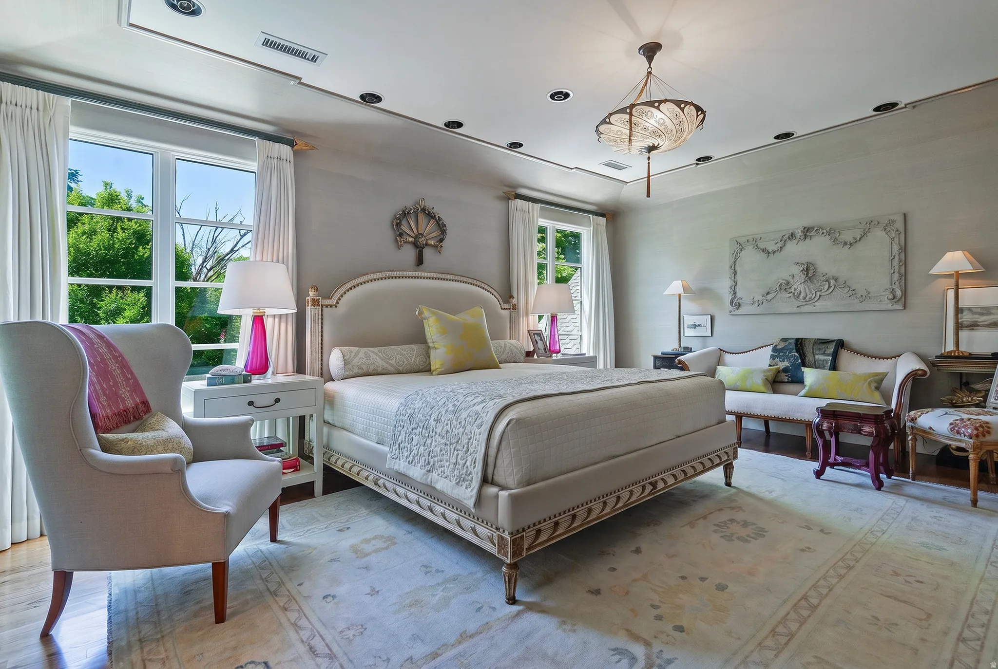 Spacious bedroom featuring wood-finish flooring, a decorative chandelier, recessed lighting, and large windows with garden scenery