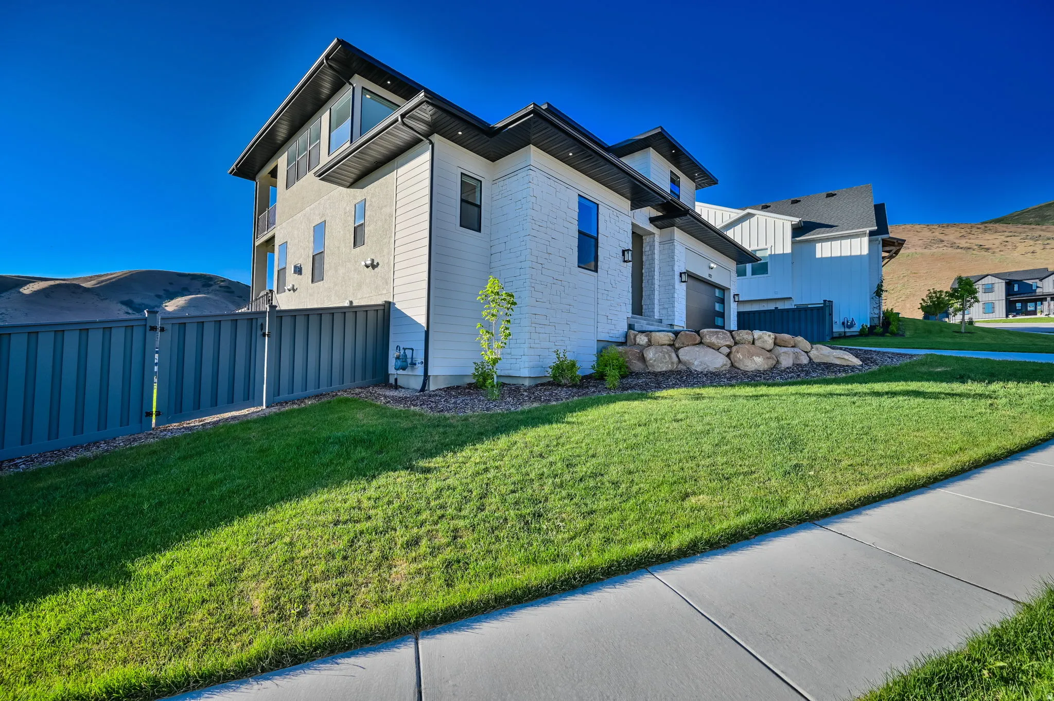 Contemporary exterior featuring white brick and stucco siding