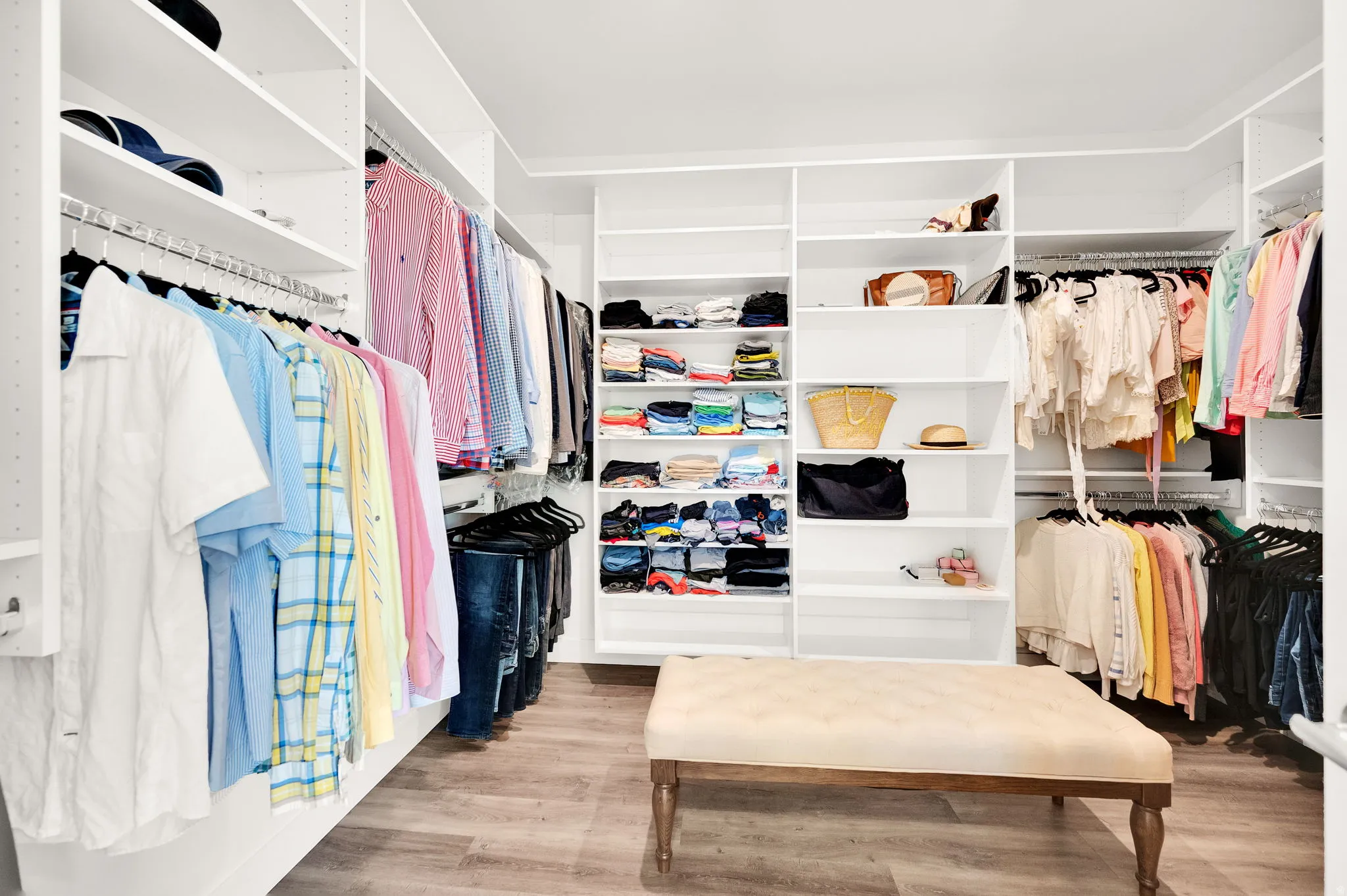 Custom built-in closet system featuring extensive shelving and multiple hanging rods