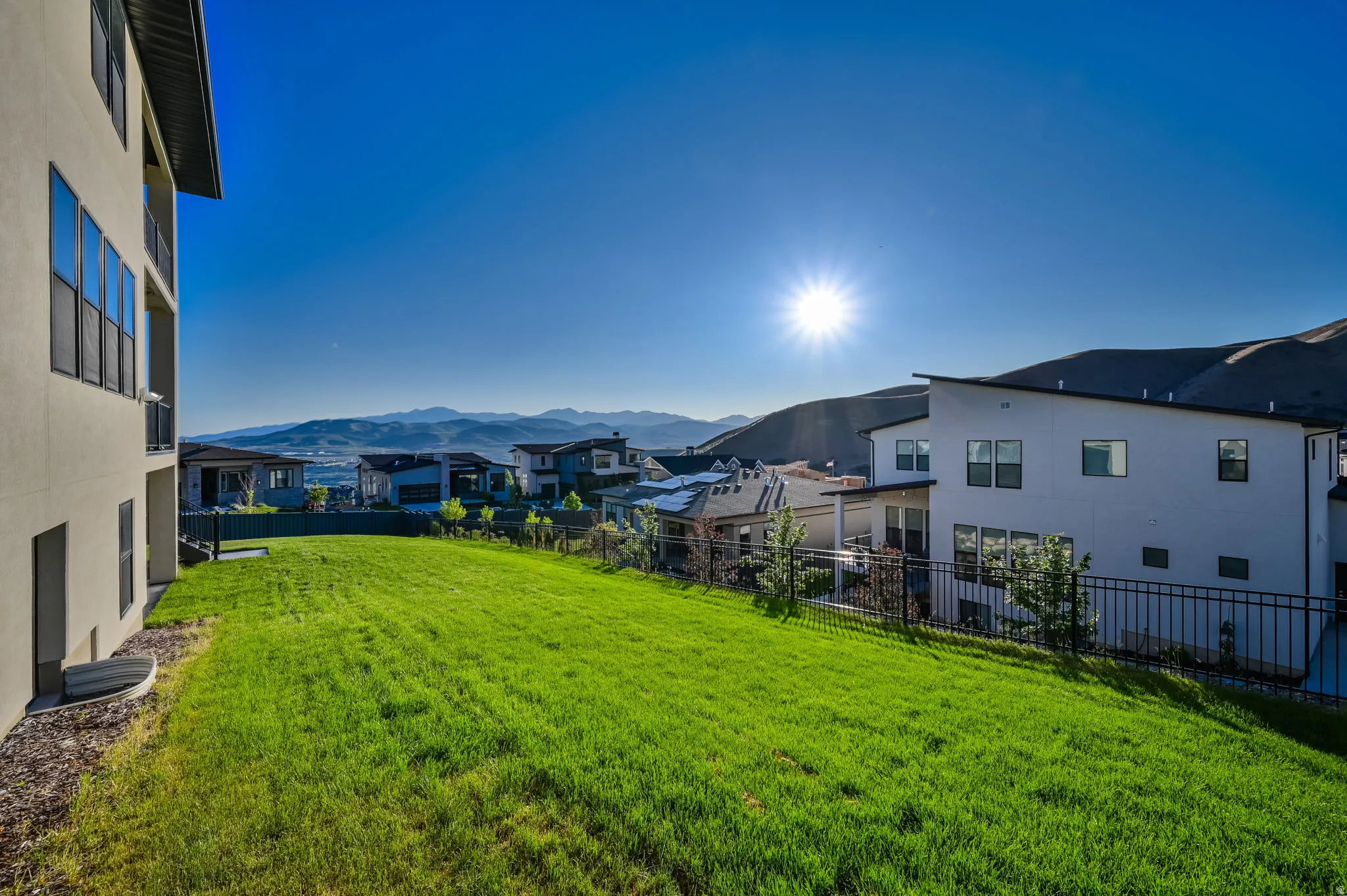 Expansive sloped lawn with mountain backdrop