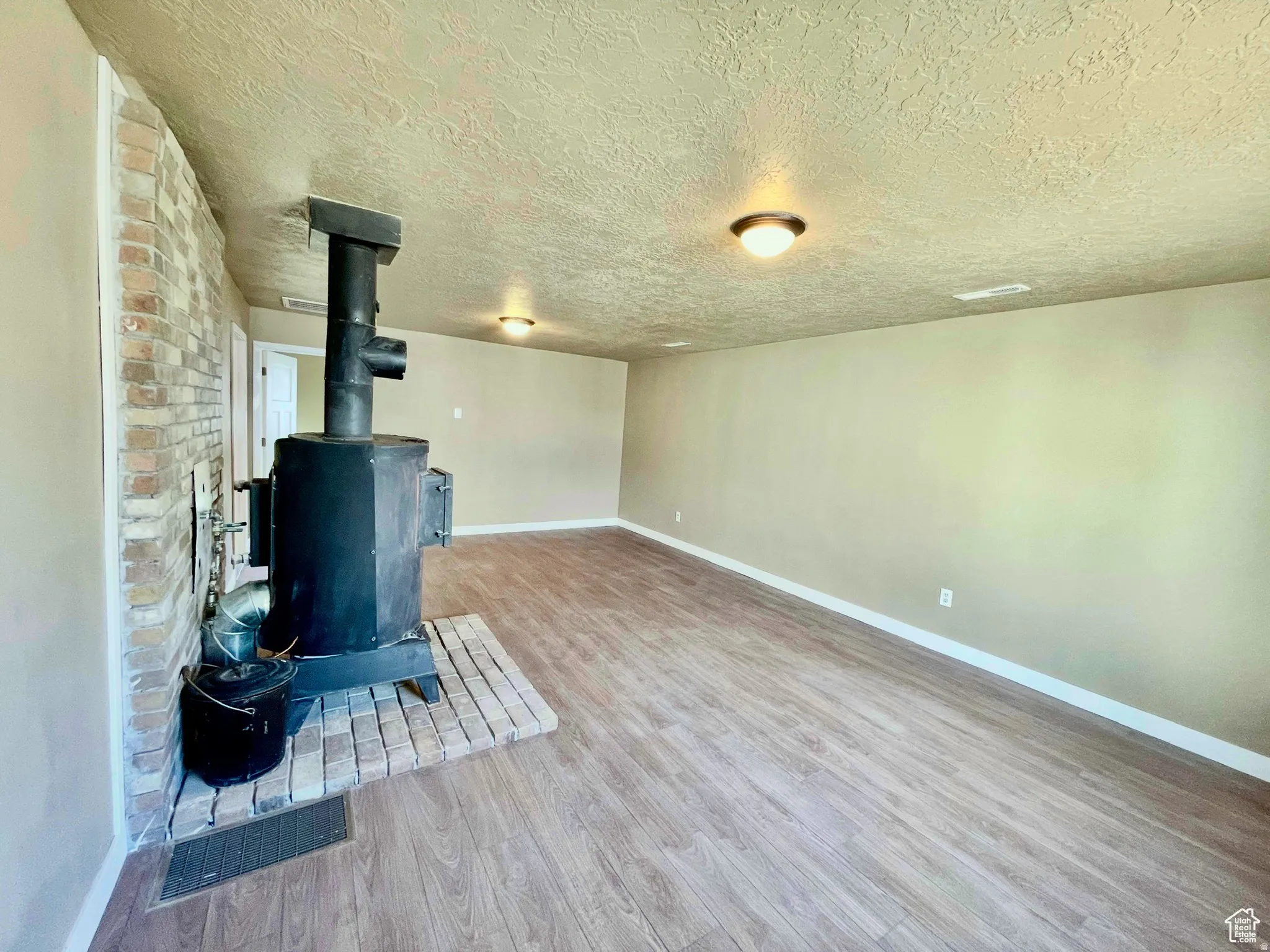 Interior room featuring a wood-burning stove with brick hearth and surround