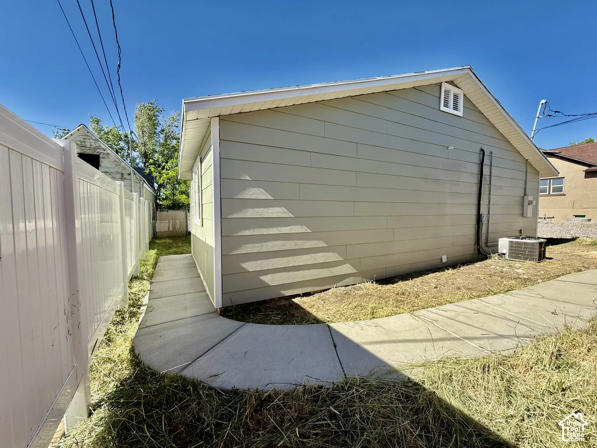 Exterior siding in a light neutral tone with white trim
