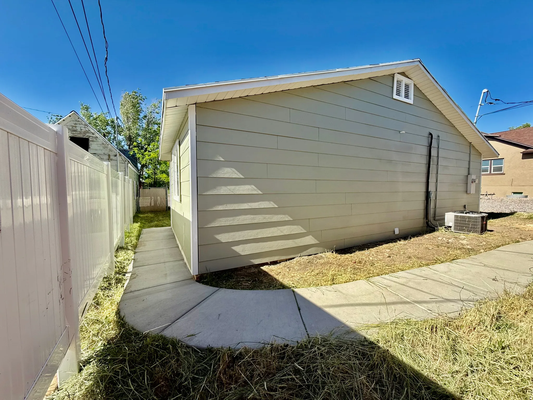Exterior siding in a light neutral tone with white trim