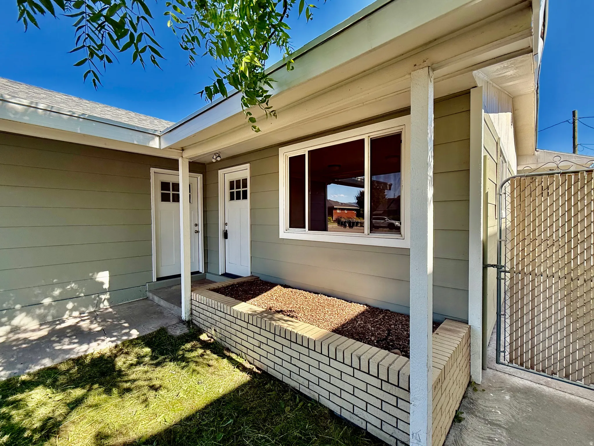 Light green horizontal siding with white trim