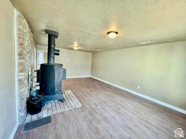 Interior room featuring a wood-burning stove with brick hearth and surround