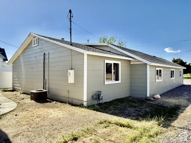 Exterior featuring horizontal siding, white trim, a gabled roofline, and multiple windows