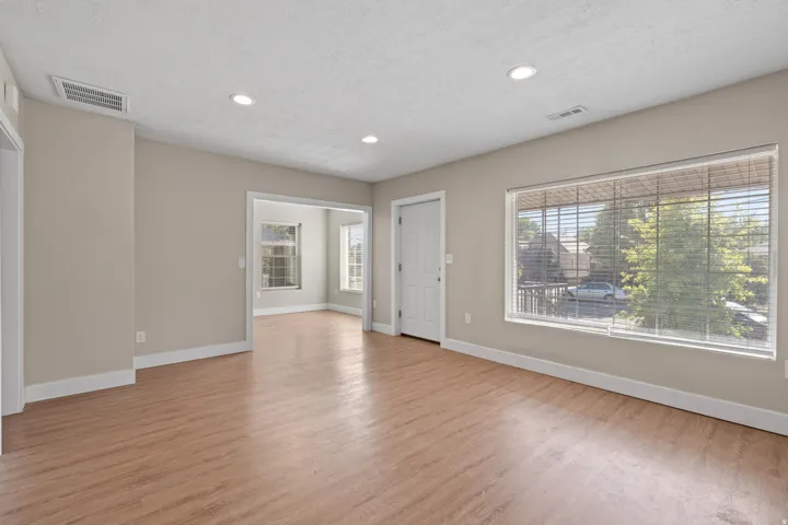 Spacious interior featuring wood-finish flooring, recessed lighting, and neutral wall tones