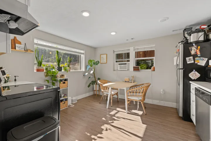 Kitchen space featuring wood-finish flooring, recessed lighting, and multiple windows