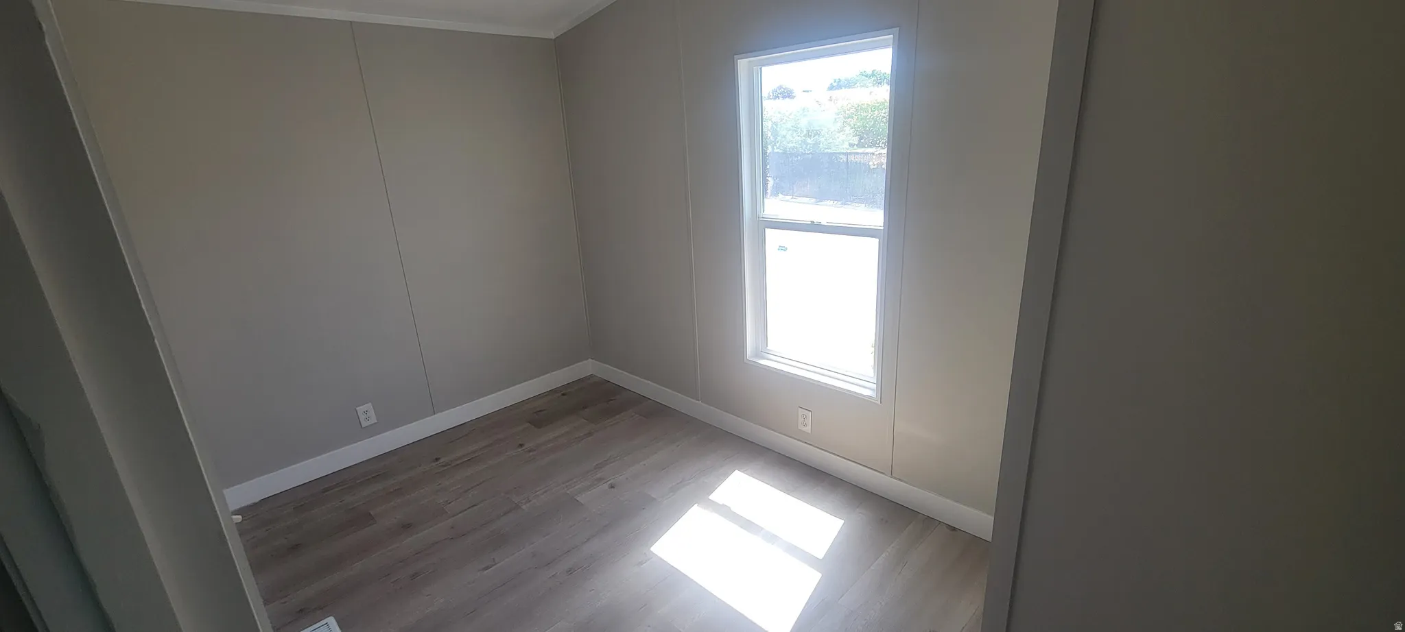 Room with wood-finish flooring and a single window