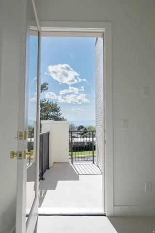 Private outdoor balcony with black metal railings and painted brickwork