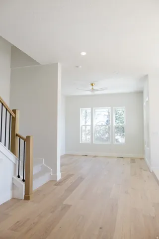Open-concept living space with light wood-finish flooring