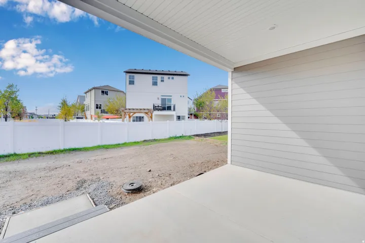 Covered concrete patio with horizontal siding and a smooth soffit ceiling