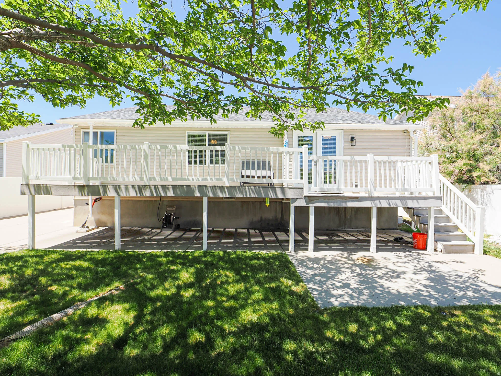 Rear exterior featuring a multi-level deck with white railings and an outdoor staircase