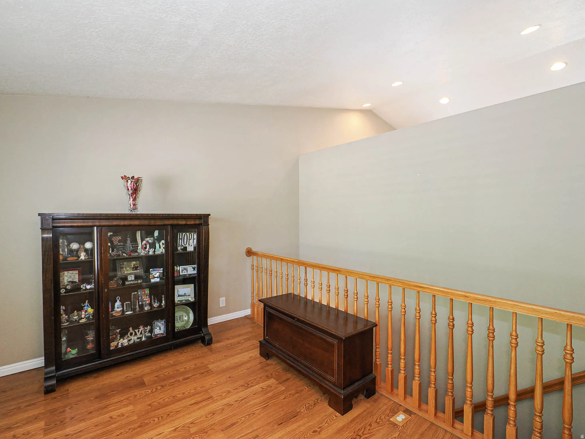 Hardwood-finish flooring throughout, featuring a natural wood handrail and baluster system