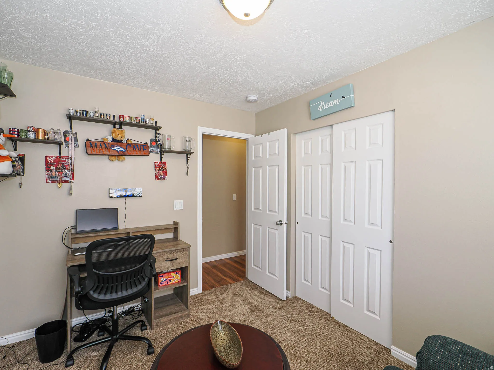 Carpeted room with neutral-toned walls, white trim, and a ceiling-mounted light fixture
