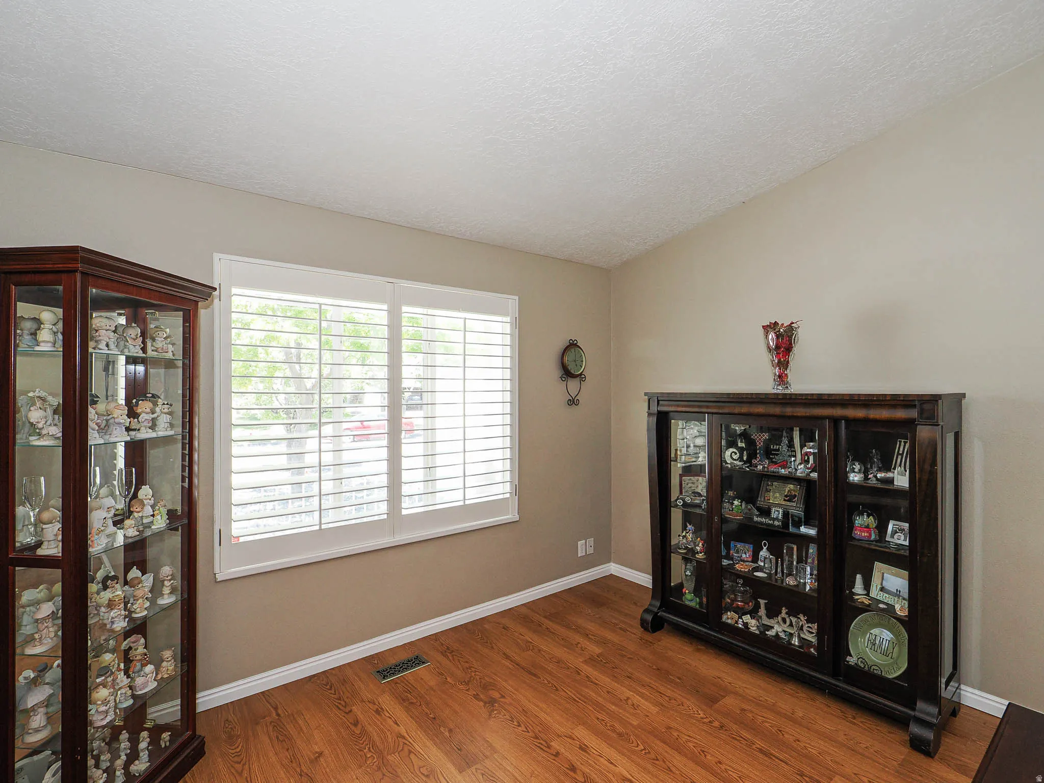 Room featuring warm neutral wall tones and wood-finish flooring