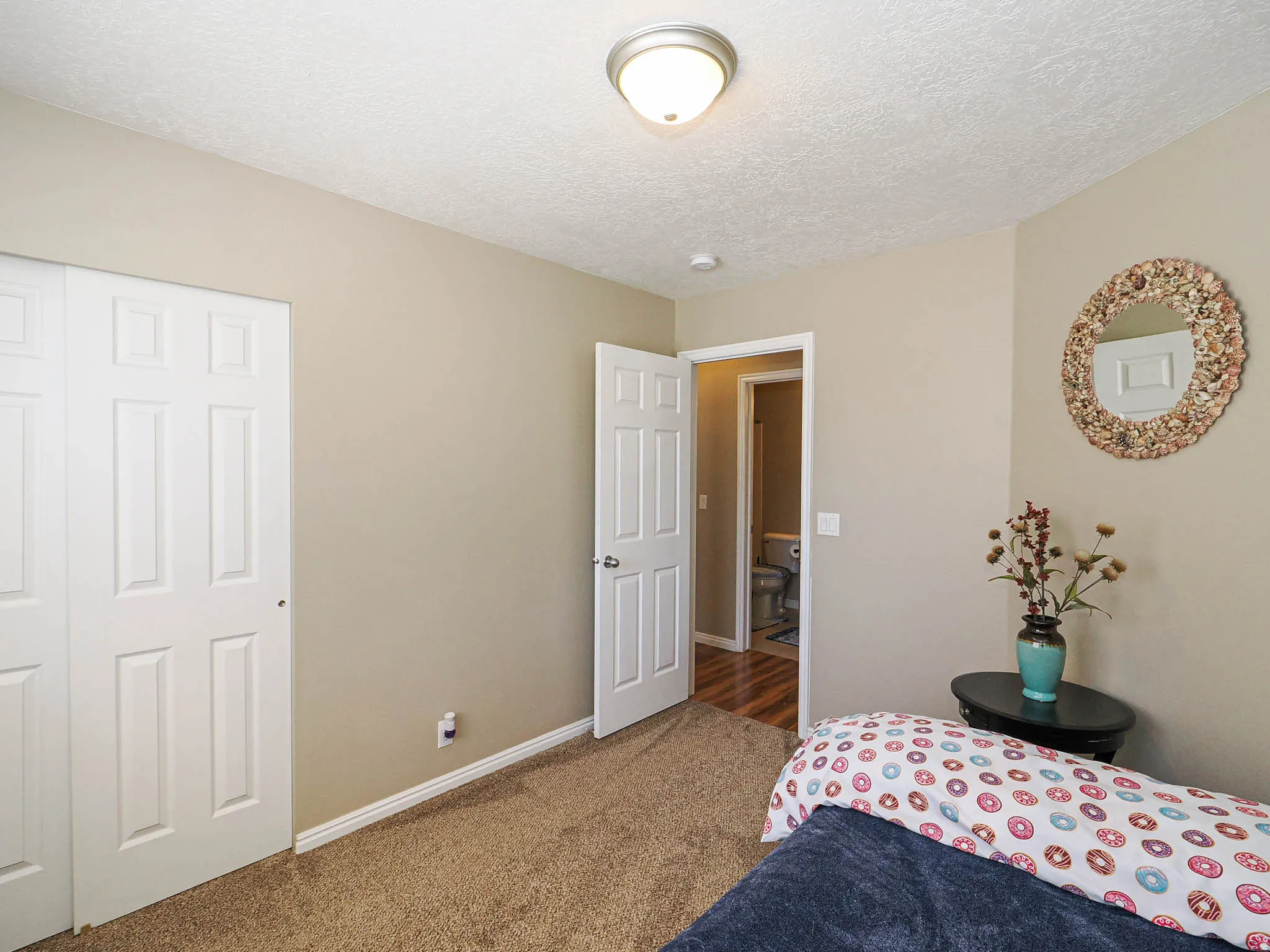 Carpeted interior space with neutral wall tones and a textured ceiling