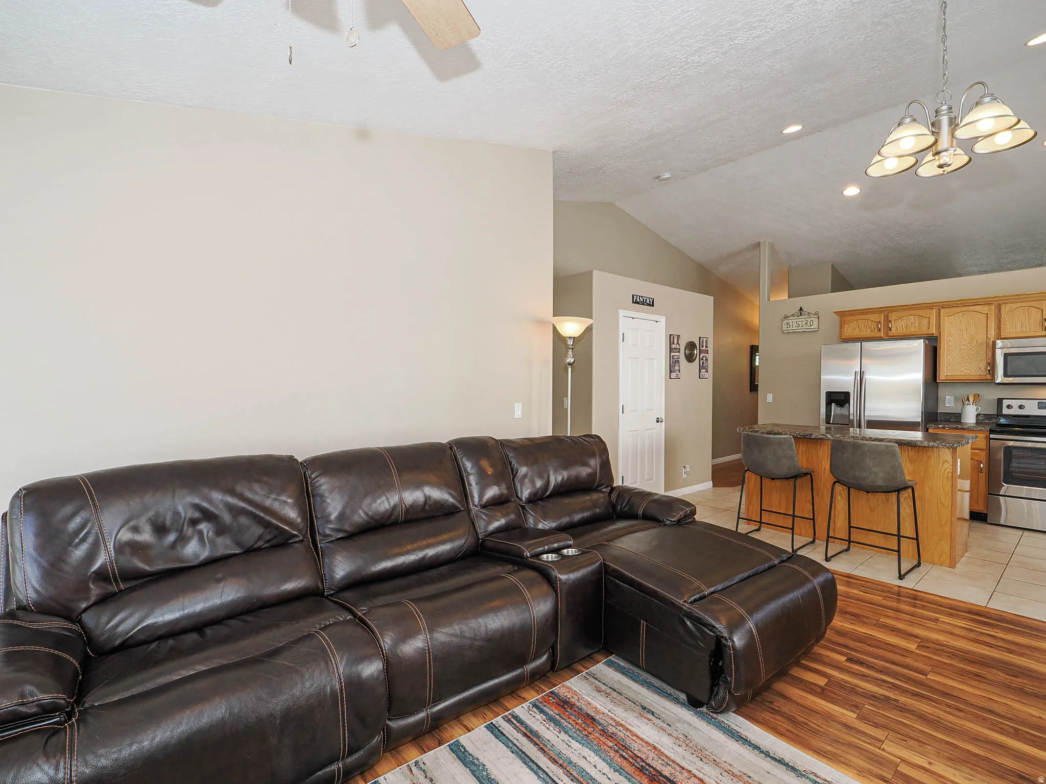 Open-concept living area with wood-finish flooring in the foreground