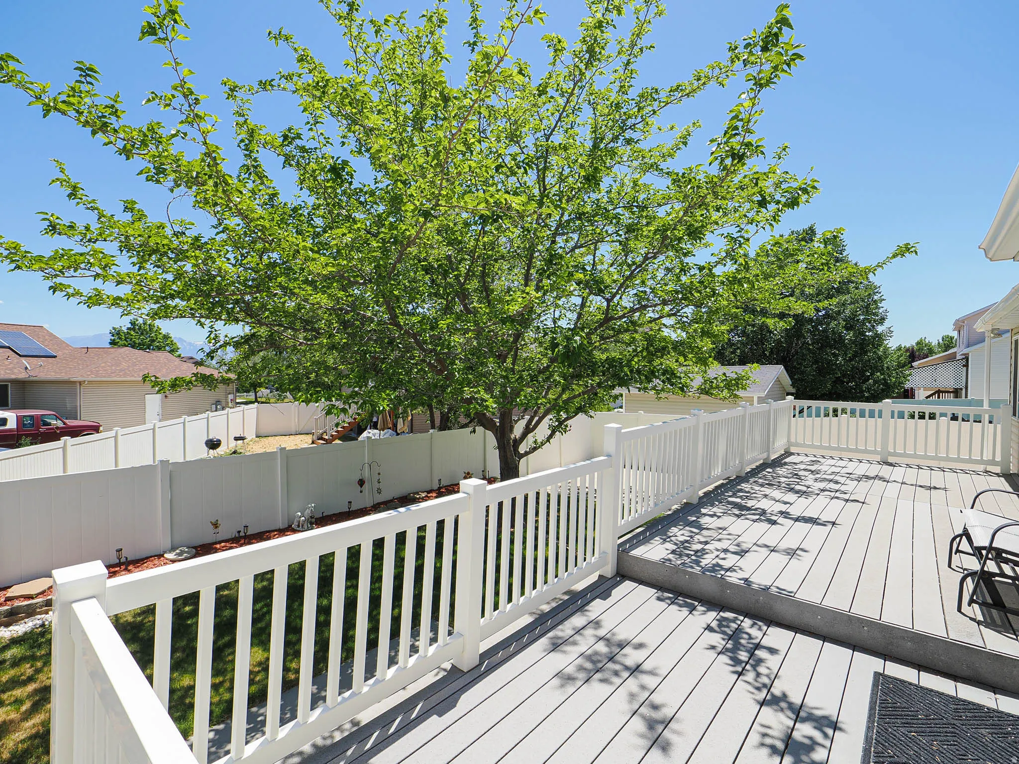 Expansive composite deck featuring a multi-level design and white railings