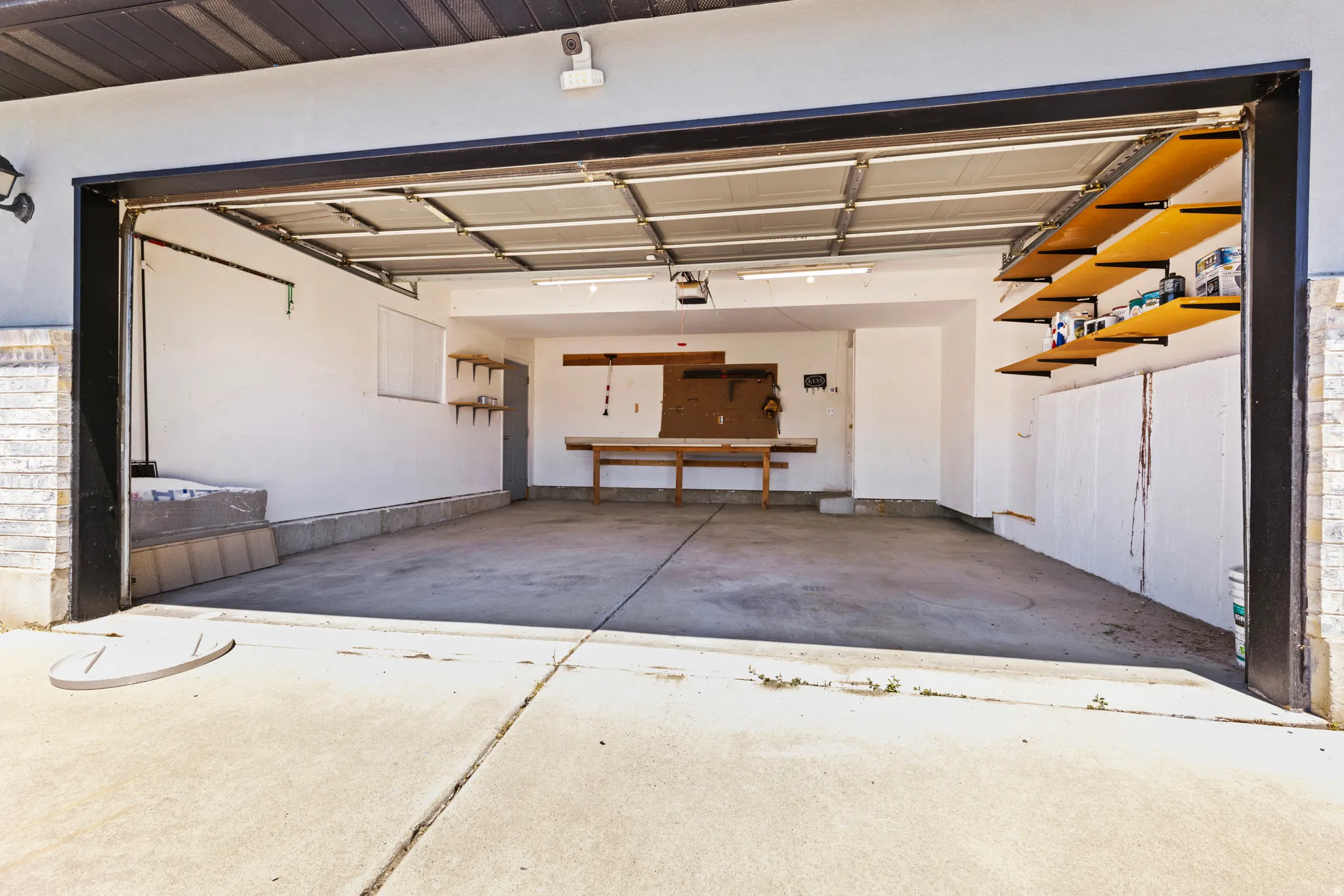 Two-car garage with a concrete floor and white painted walls