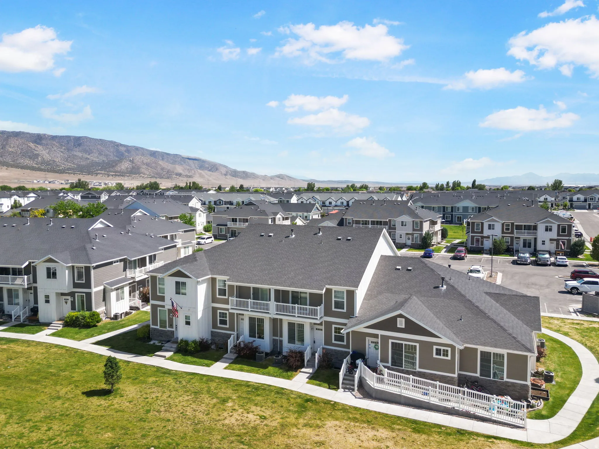 Residential community featuring multi-level townhomes with gray shingle roofs