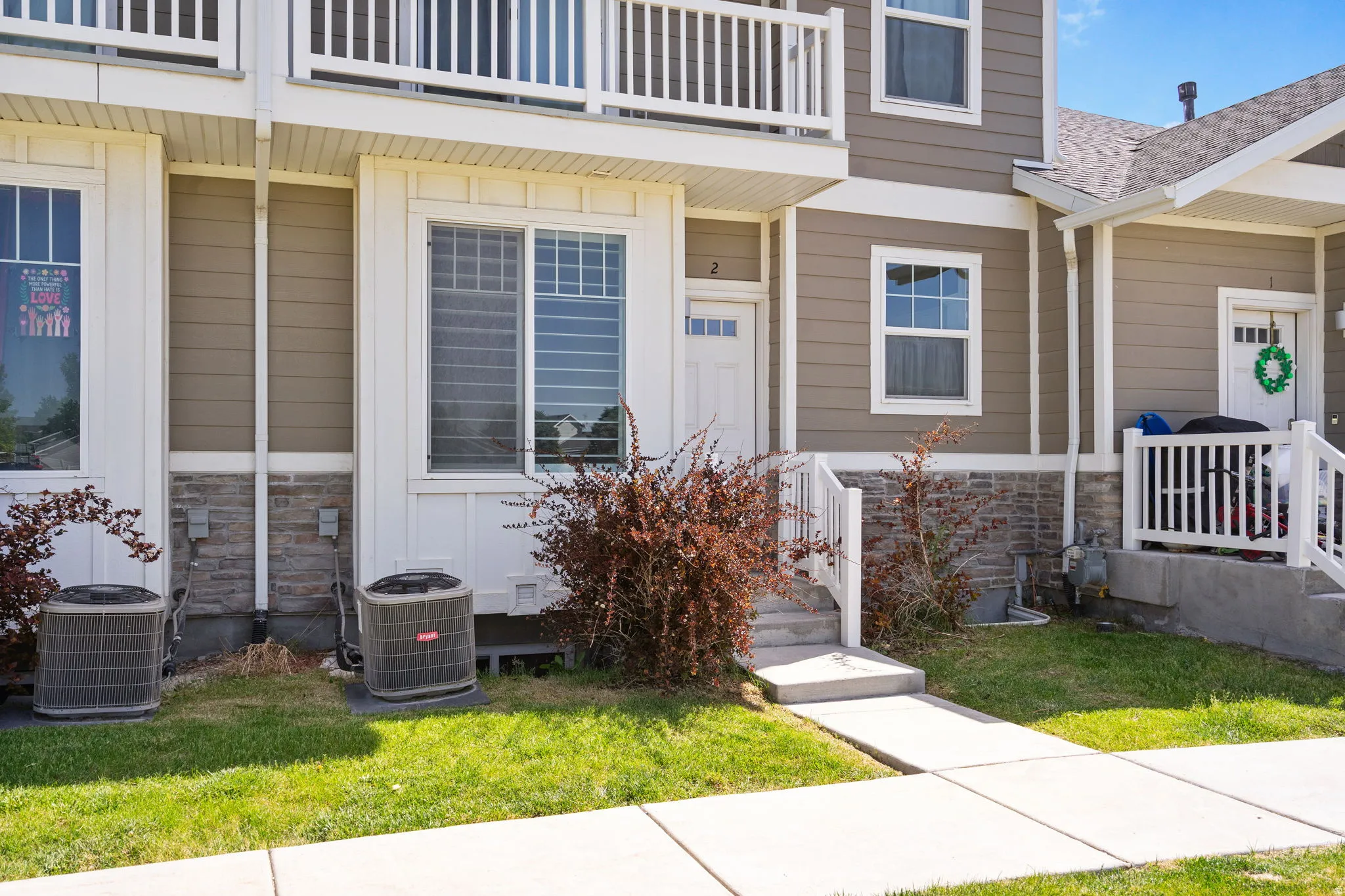 Townhome exterior featuring neutral siding and white trim