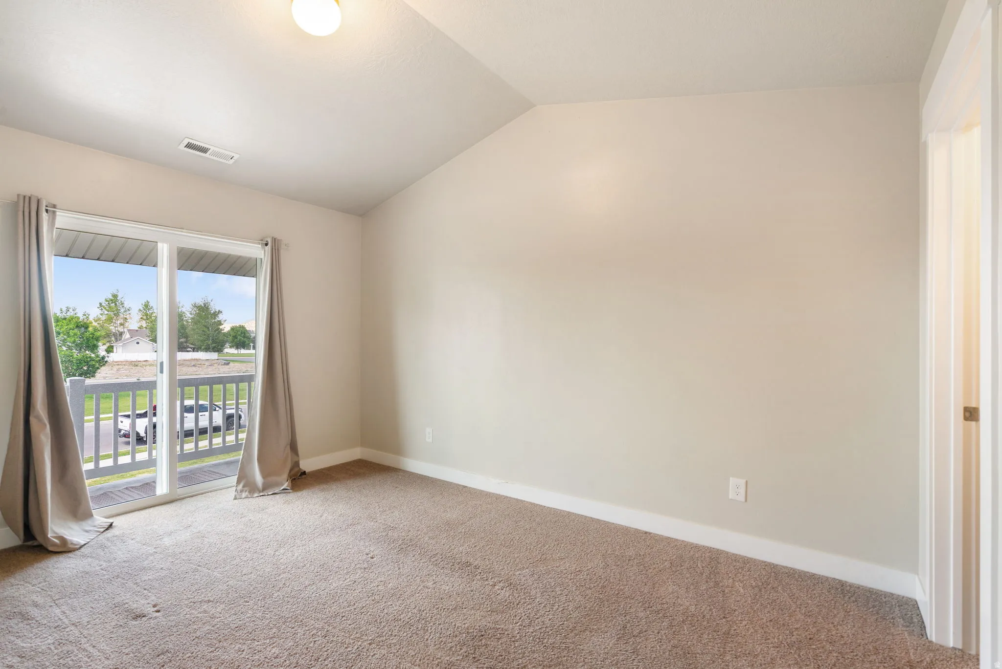 Primary Bedroom with balcony access and walk in closet.