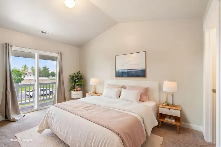 Virtually staged, Primary Bedroom, with walk-in closet and balcony.