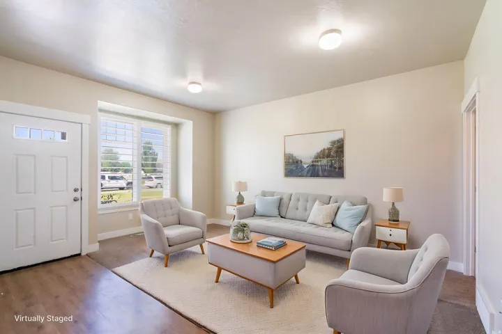 Bright living area with wood-finish flooring and neutral wall tones