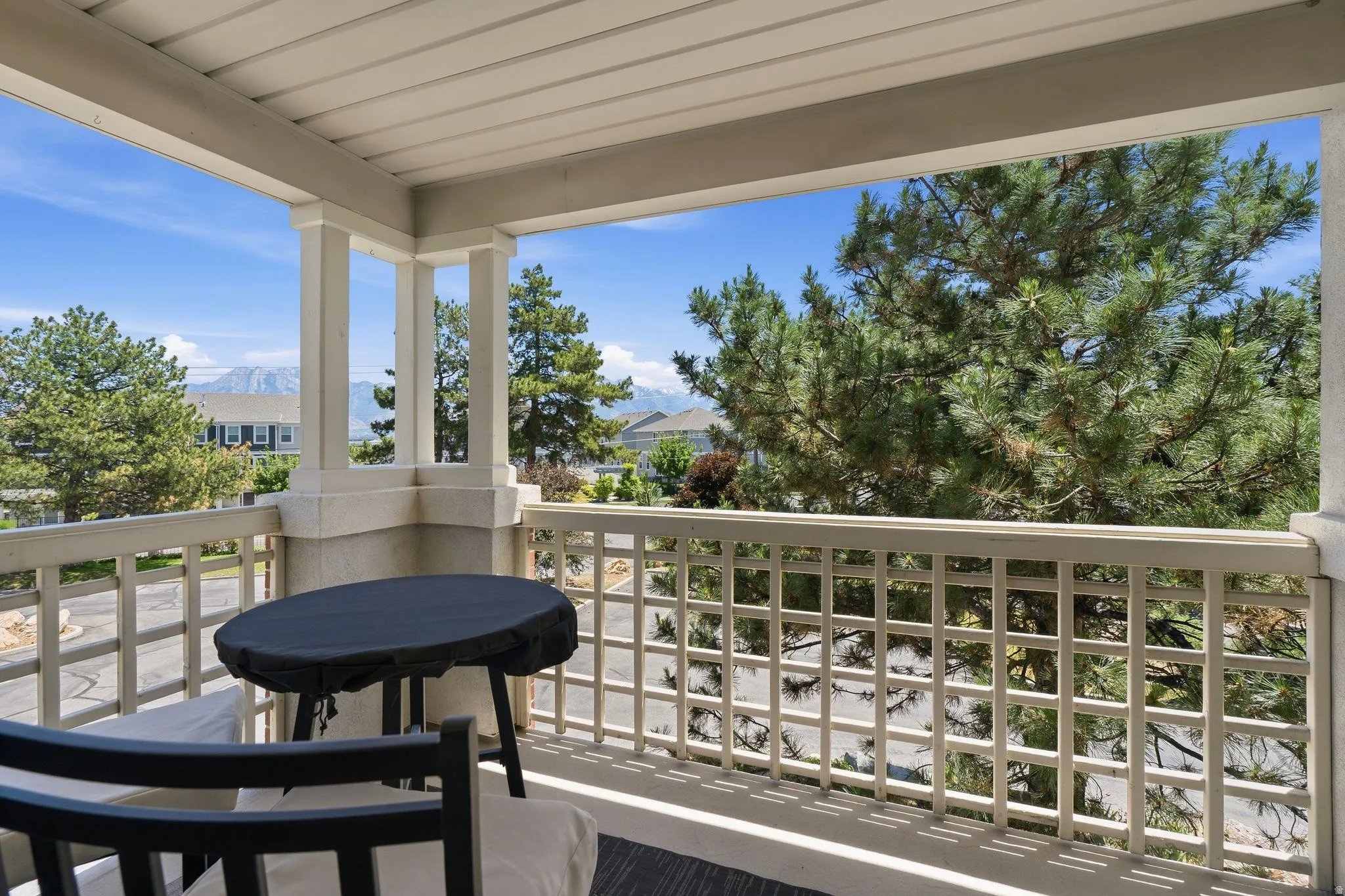 Covered outdoor balcony with great mountain view.