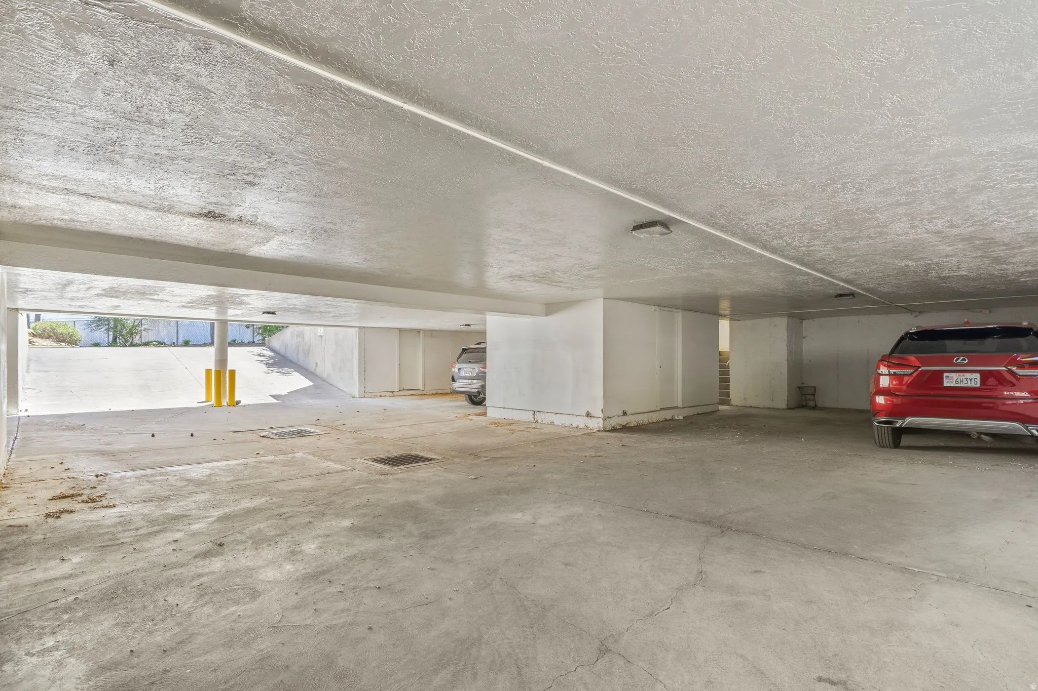 Covered underground parking structure with concrete flooring and heated ramp.  Includes storage area.