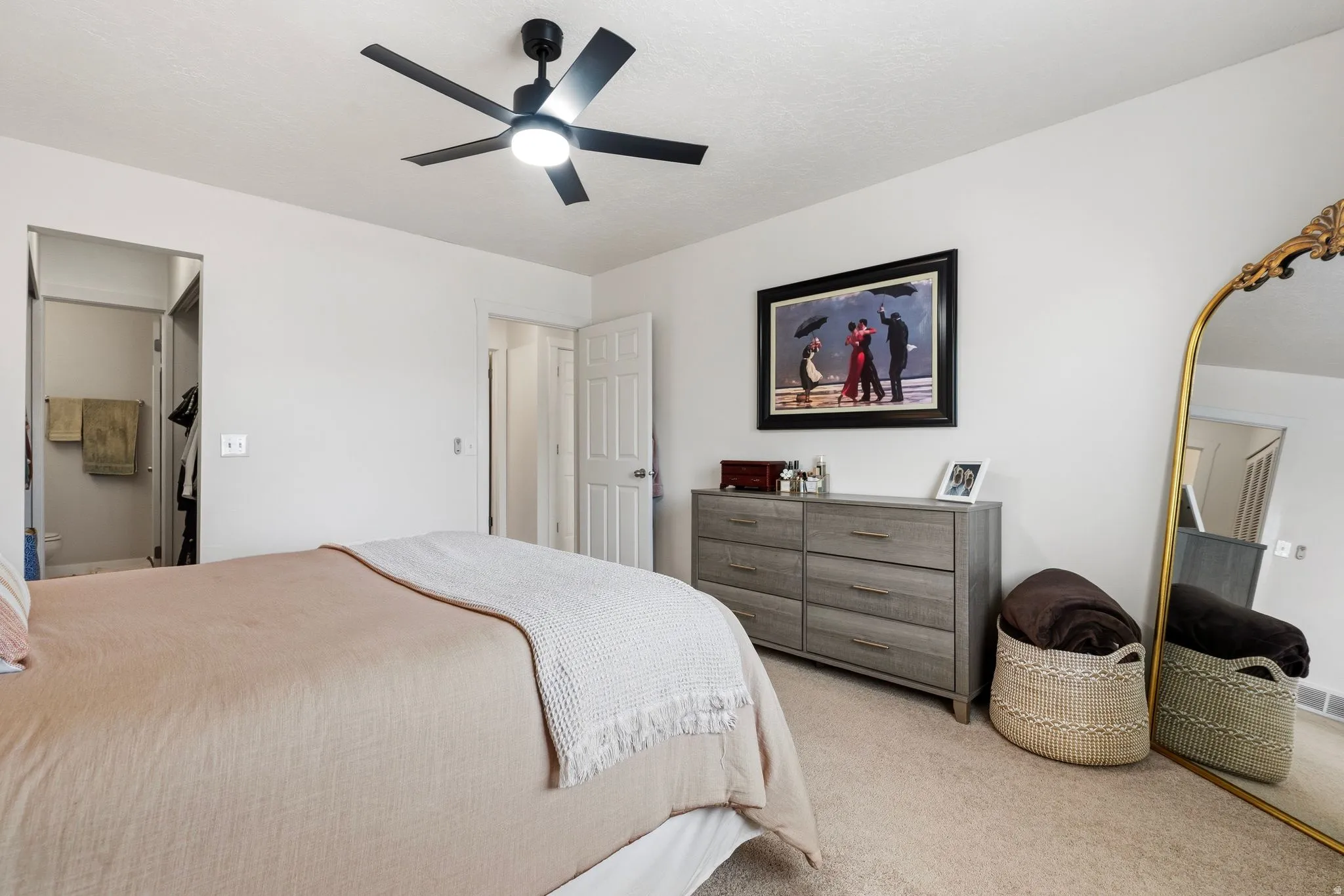 Spacious Primary bedroom featuring a lighted ceiling fan.