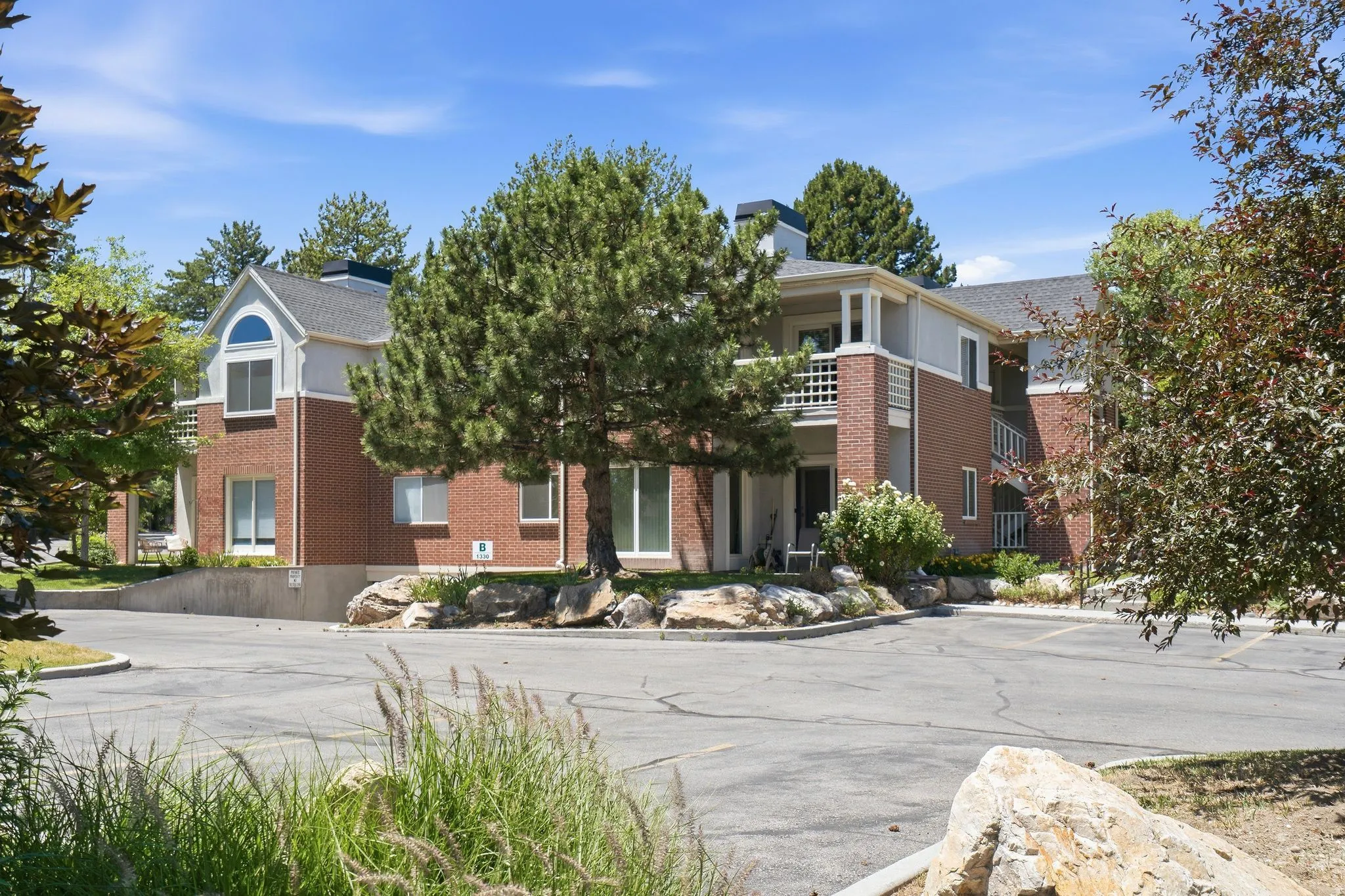 Multi-story building featuring brick and siding facade