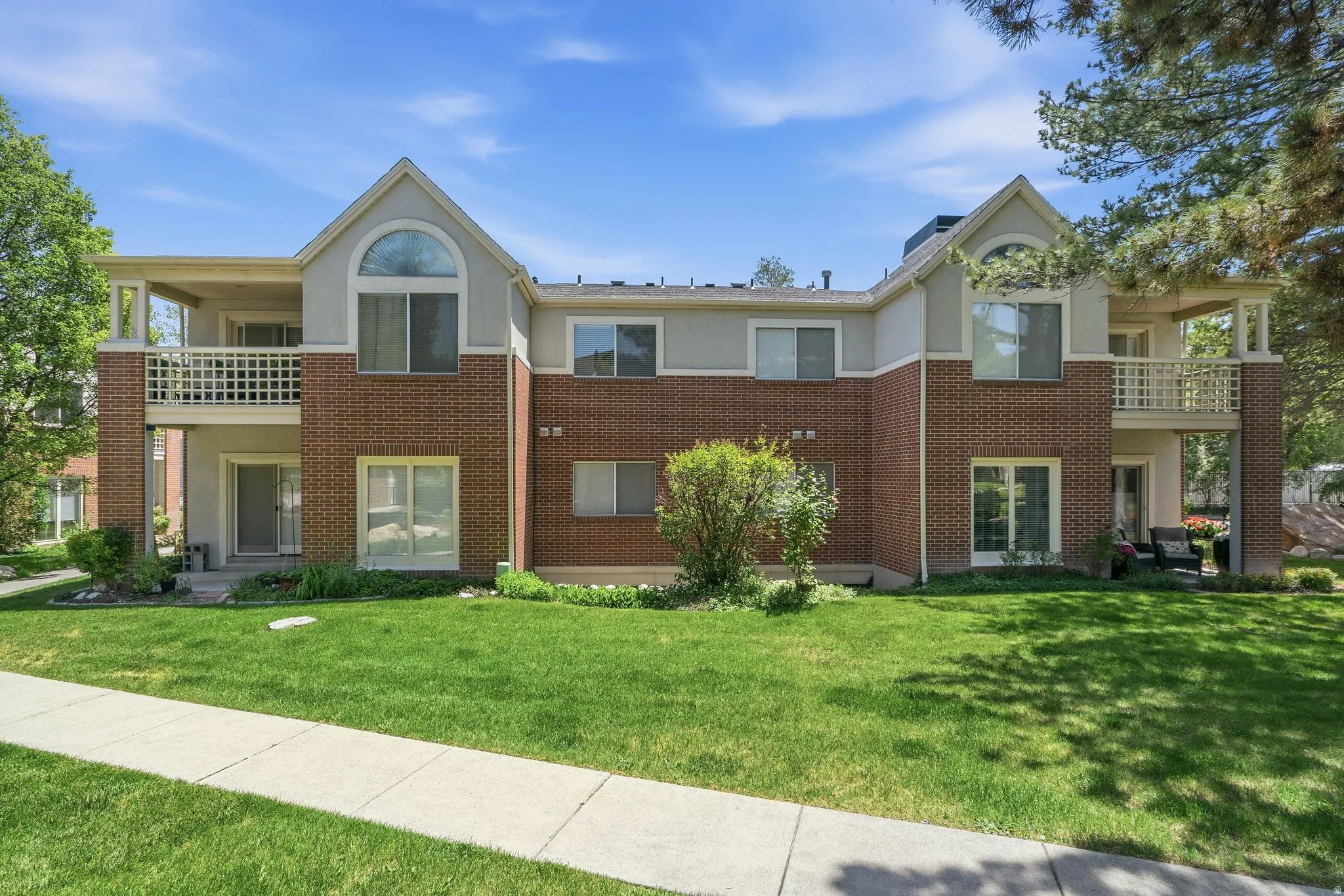Brick and stucco exterior featuring two-story construction with gabled roof lines