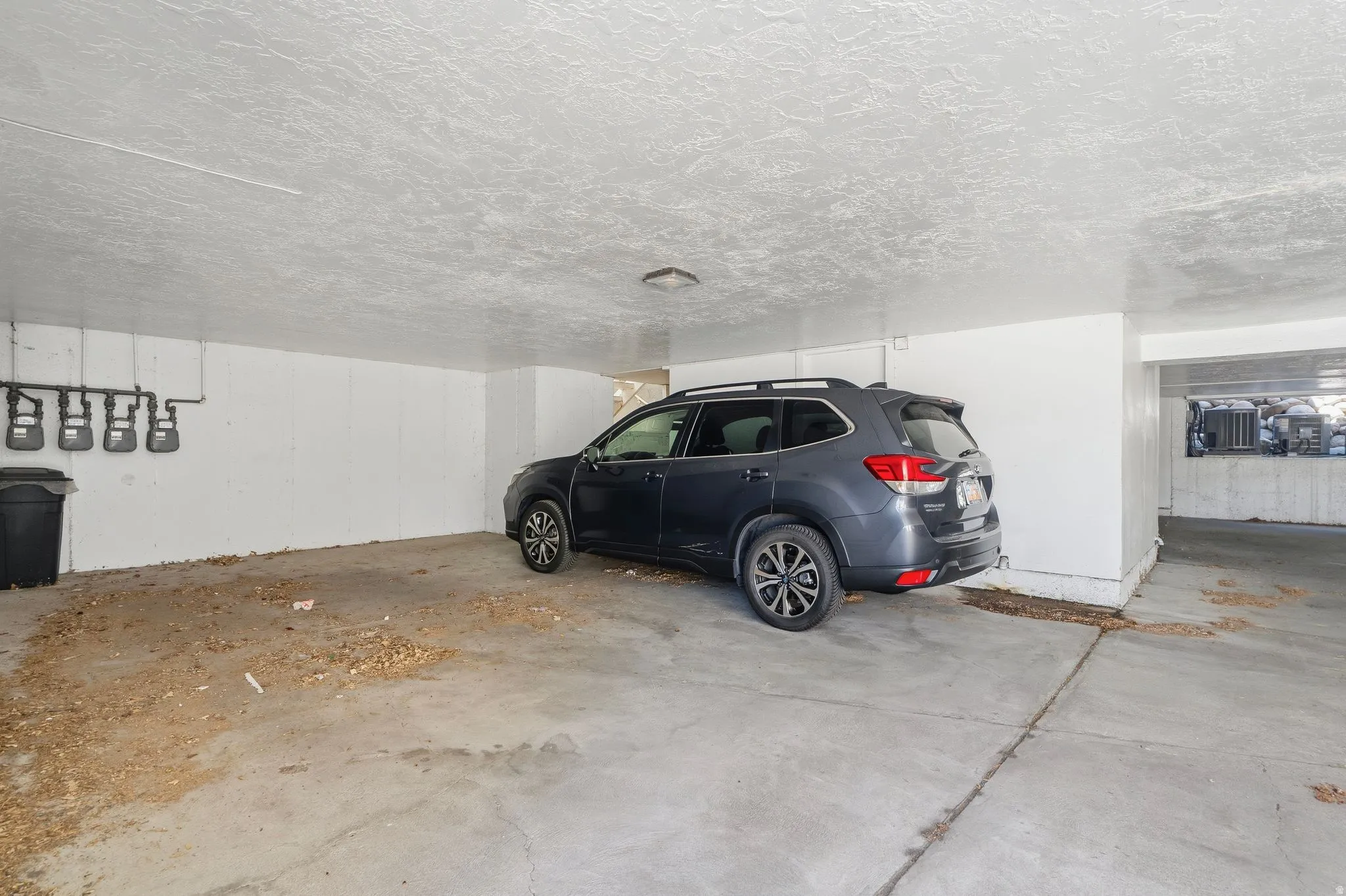 Covered underground parking for one vehicle and includes storage area.